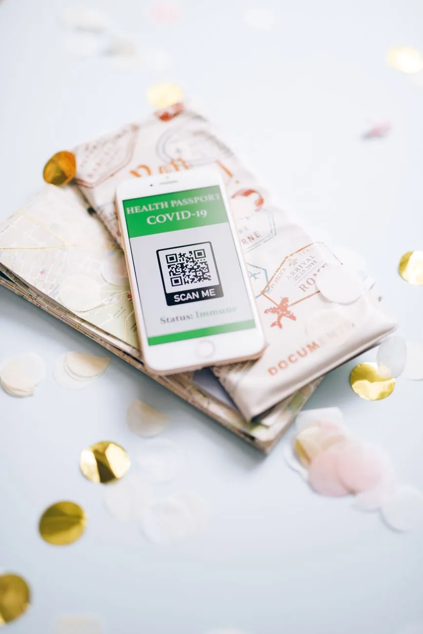 A health passport for COVID-19 displayed on a map with confetti, symbolizing safe travel planning during the pandemic.
